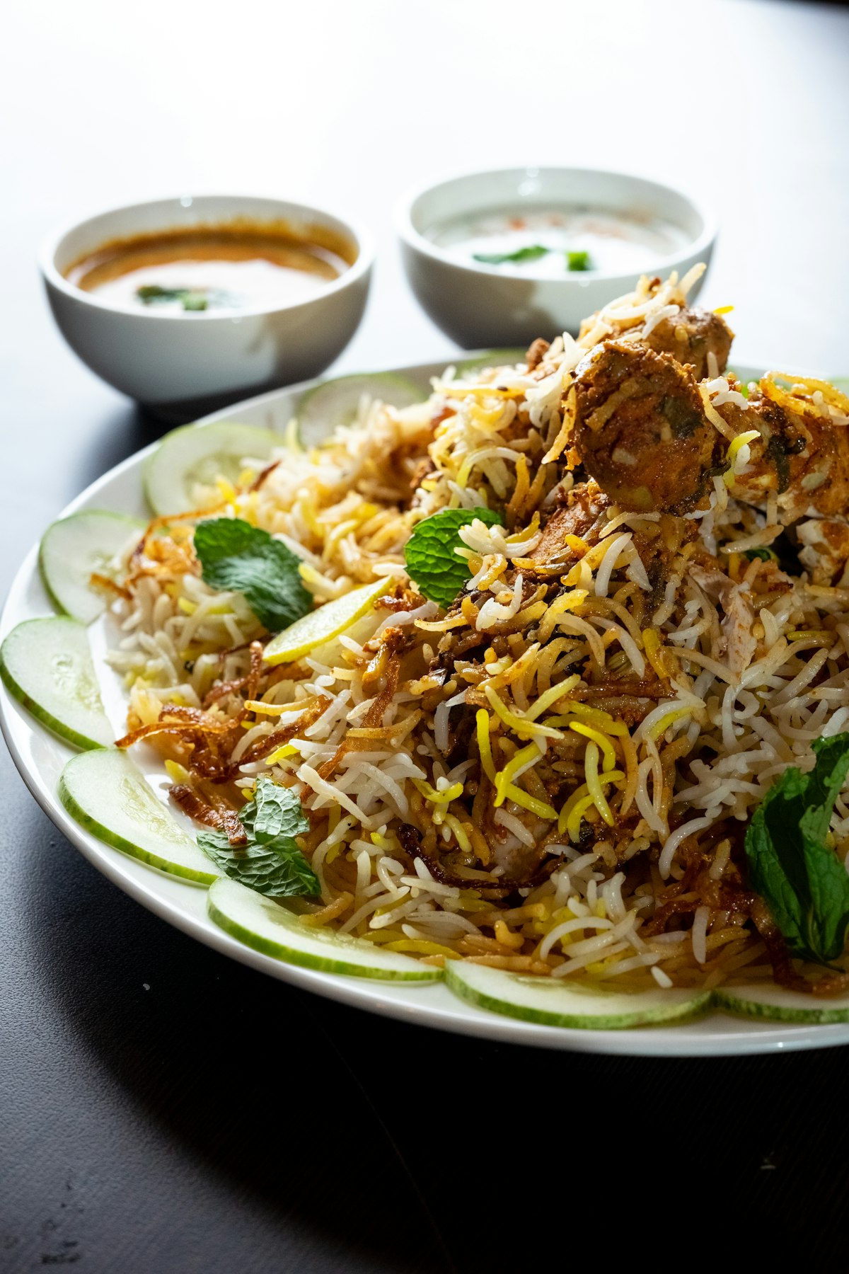 Illustrative concept photo of a Pakistani meal spread with biryani, handi, and flatbread